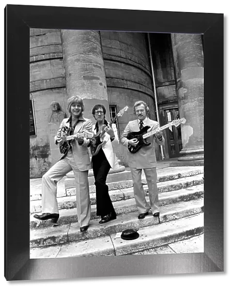 Singing in the street are left to right: Joe Brown, Hank Marvin, Bert Weedon