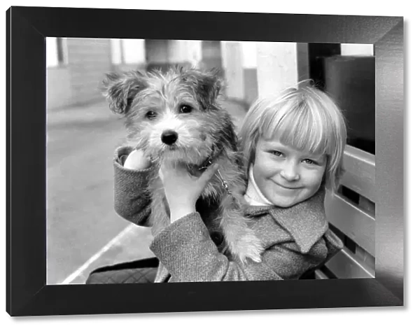 Cute children and Animals: Young girl holding her puppy dog. January 1980 80-00007-004