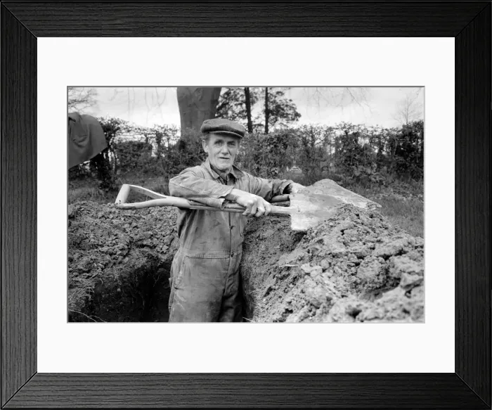 Framed Print : Is work wonderful?. Feature. Grave Digger at work in the grave yard of Windlesham Church Framed Print : Is work wonderful?. Feature. Grave Digger at work in the grave yard of Windlesham Church
