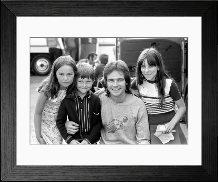 Framed Print : Barry Sheene signs autographs for three young children who broke through the security to