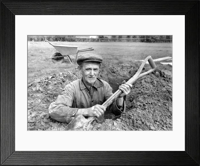 Framed Print : Is work wonderful?. Feature. Grave Digger at work in the grave yard of Windlesham Church Framed Print : Is work wonderful?. Feature. Grave Digger at work in the grave yard of Windlesham Church