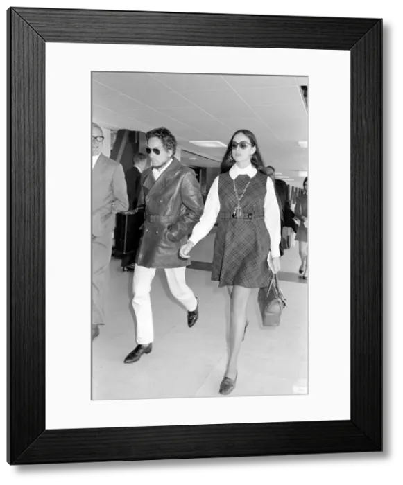 Framed Print : American folk singer, Bob Dylan and his wife left Heathrow Airport today to return home