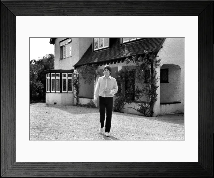 Framed Print : Beatles singer Paul McCartney relaxing in the grounds of his father