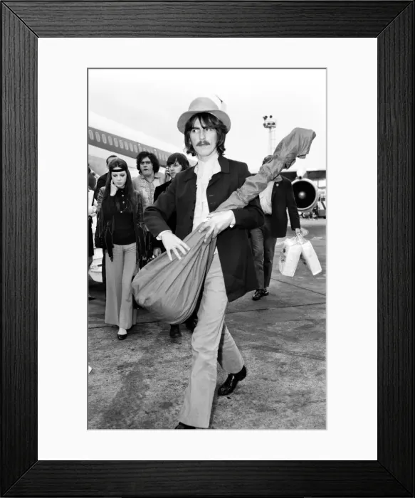 Framed Print : Beatles guitarist George Harrison complete with sitar at Heathrow Framed Print : Beatles guitarist George Harrison complete with sitar at Heathrow