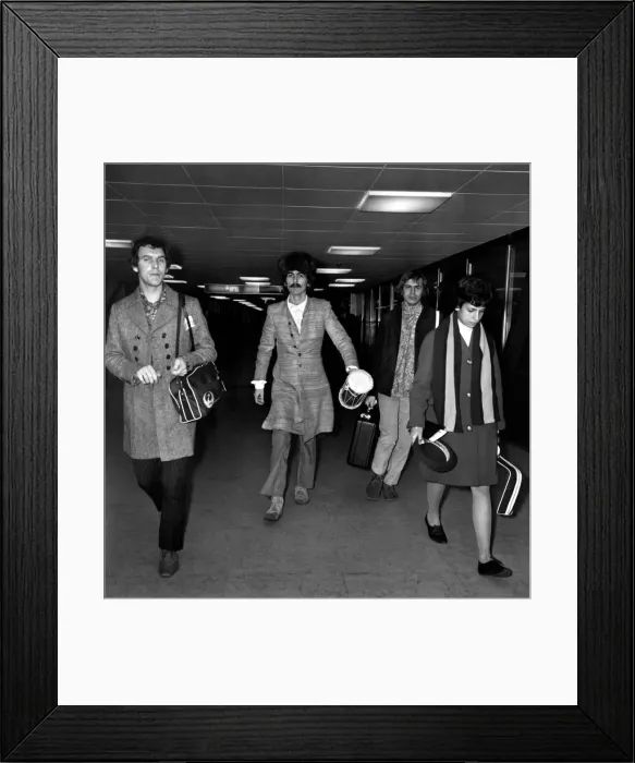 Framed Print : George Harrison of the Beatles at Heathrow airport where he arrived from India where he
