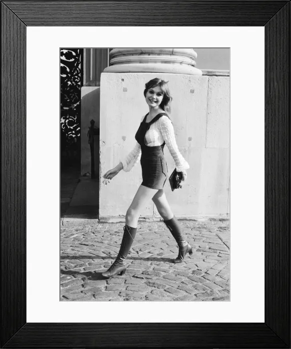 Framed Print : Model and horror film actress Madeline Smith poses wearing hot pants suit with knee high