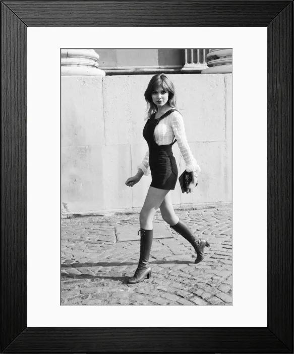 Framed Print : Model and horror film actress Madeline Smith poses wearing hot pants suit with knee high