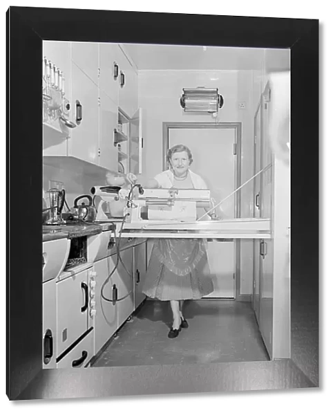 Mrs Susan Davies seen here using her rotary iron in a kitchen full of labour saving