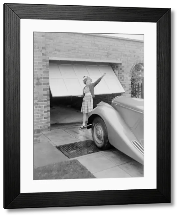 Framed Print : Susan Davies seen here opening the garage door for her father Framed Print : Susan Davies seen here opening the garage door for her father
