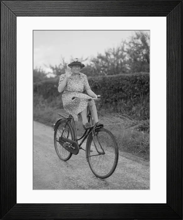 Framed Print : Mrs Hilda Baker seen here coasting downhill on her bicycle with her feet up on the front Framed Print : Mrs Hilda Baker seen here coasting downhill on her bicycle with her feet up on the front