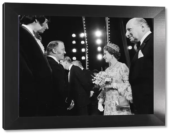 Her Majesty Queen Elizabeth II, escorted by Media mogul Lew Grade (right)