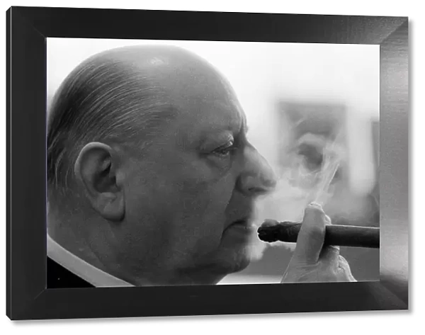 Media Mogul Lew Grade, head of ATV television, smoking of one of his trademark cigars