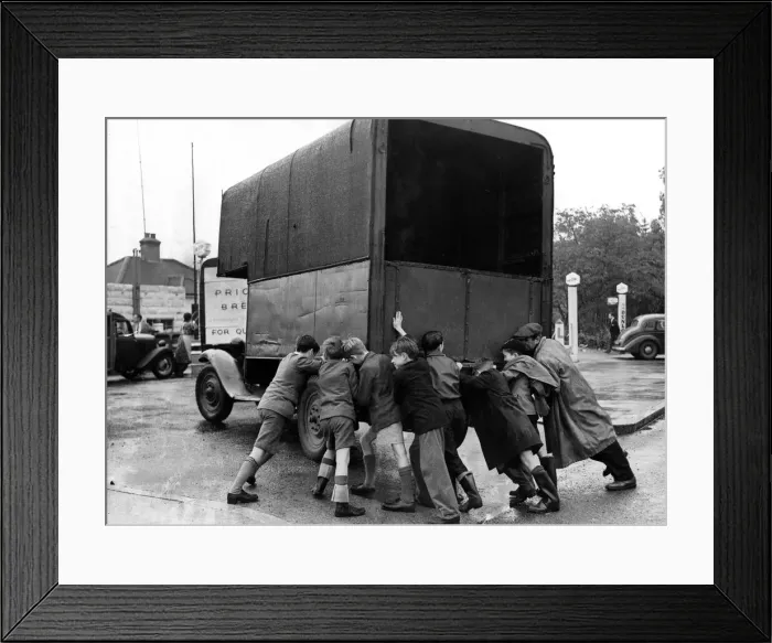 Framed Print : Petrol Shortages 1953. Boys pushing a lorry which has run out of fuel Framed Print : Petrol Shortages 1953. Boys pushing a lorry which has run out of fuel