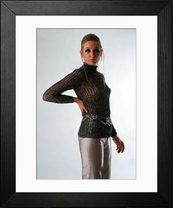Framed Print : A model wearing a see through chain mail sweater and silver trousers Framed Print : A model wearing a see through chain mail sweater and silver trousers