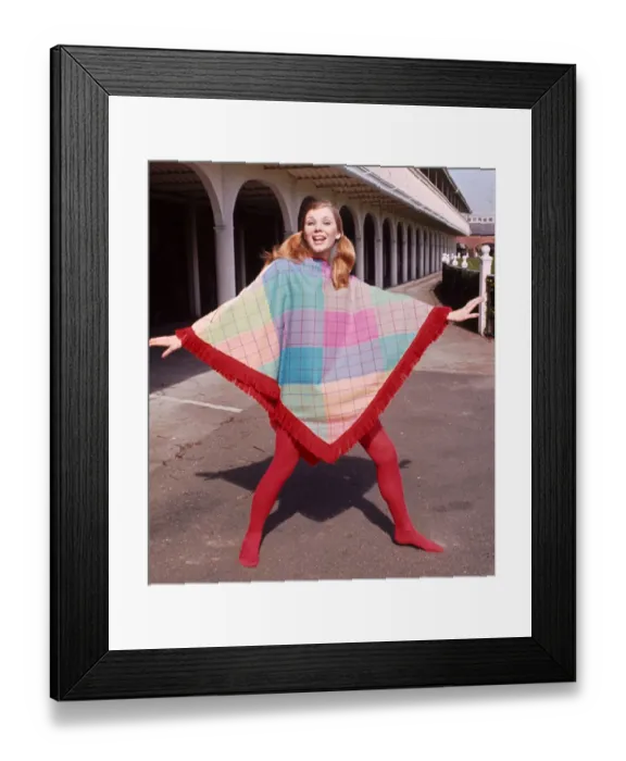 Framed Print : Model wearing a fringed poncho design by J P Fashion with red stockings