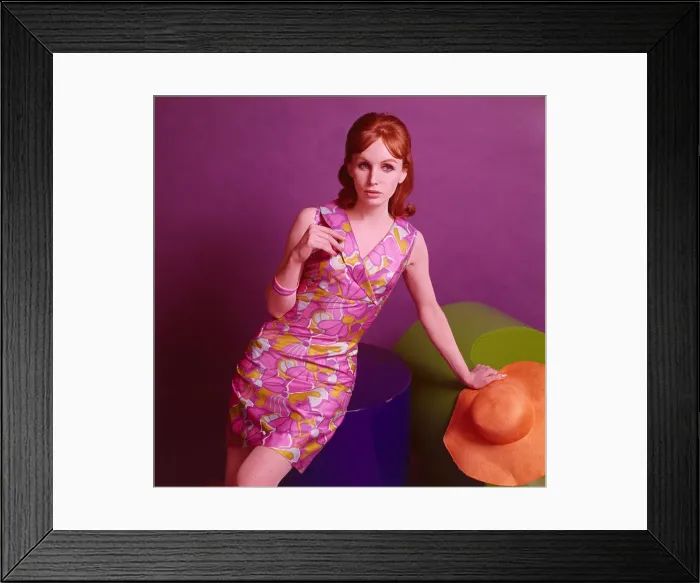Framed Print : Model wearing a satinised cotton dress with a purple floral pattern, May 1967 Framed Print : Model wearing a satinised cotton dress with a purple floral pattern, May 1967
