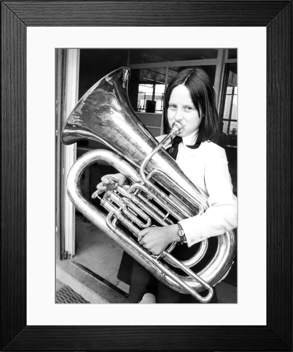Framed Print : Nine year old Pamela Henderson rehearsing her part with her E-flat Bass Tuba in Framed Print : Nine year old Pamela Henderson rehearsing her part with her E-flat Bass Tuba in