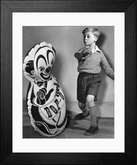 Framed Print : Young child with a large inflated balloon, bought from the seaside Circa 1955
