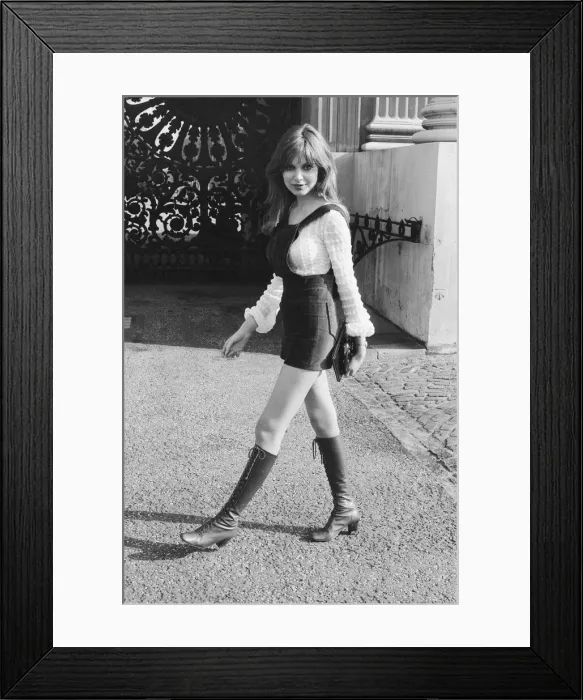 Framed Print : Model and horror film actress Madeline Smith poses wearing hot pants suit with knee high Framed Print : Model and horror film actress Madeline Smith poses wearing hot pants suit with knee high