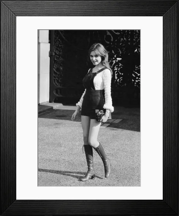 Framed Print : Model and horror film actress Madeline Smith poses wearing hot pants suit with knee high Framed Print : Model and horror film actress Madeline Smith poses wearing hot pants suit with knee high
