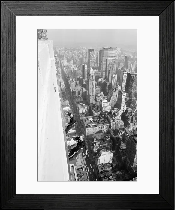 Framed Print : Workmen busy cleaning windows 1000 ft up the Empire State building in Manhatten New York