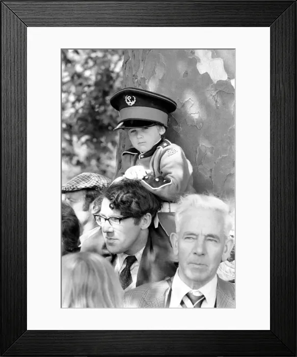 Framed Print : Trooping the colour ceremony in London. Little boy watching the ceremony wearing a large Framed Print : Trooping the colour ceremony in London. Little boy watching the ceremony wearing a large