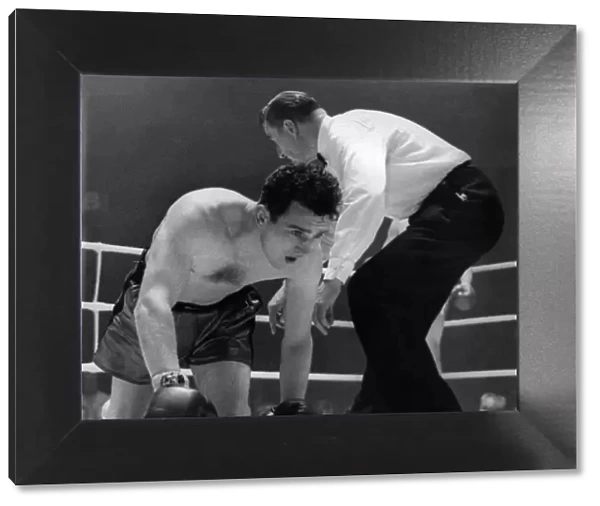 British middleweight boxer John 'Cowboy'McCormack on the canvas after being