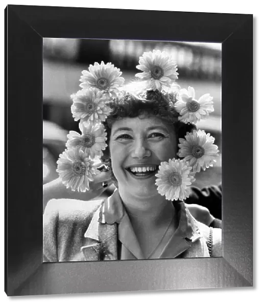 Woman wearing a headdress made of flowers. April 1980 P007842