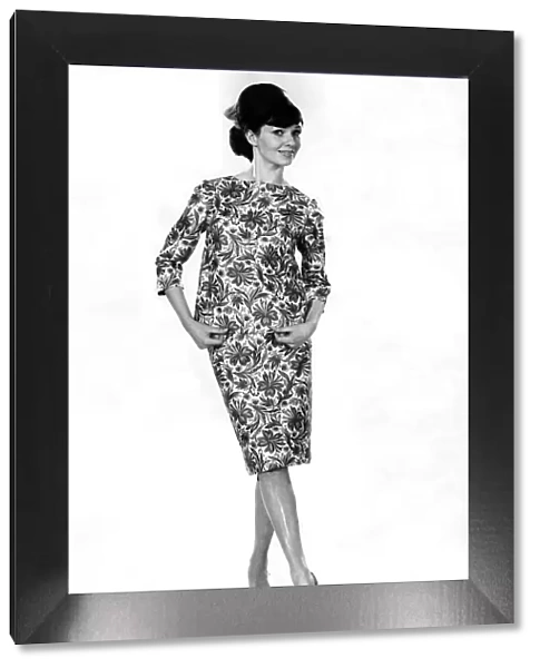 Model Merriel Weston wearing a floral patterned top and matching skirt. May 1964 P007544