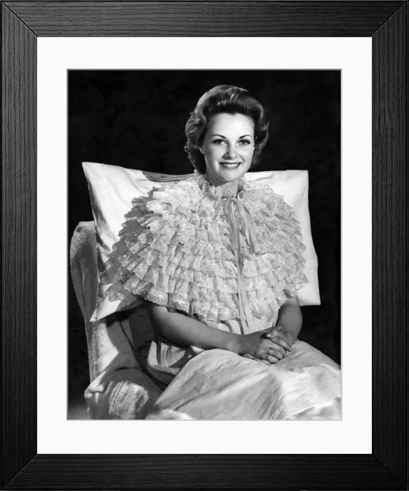 Framed Print : Model Roma Reeves wearing an unusla style nightie sitting up in bed