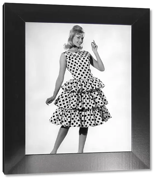 Model Jo Waring wearing a polka dot patterned dress with frills