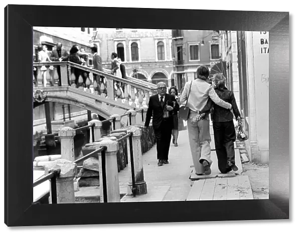 General scenes in Venice. A couple stroll along the narrow Venetian streets