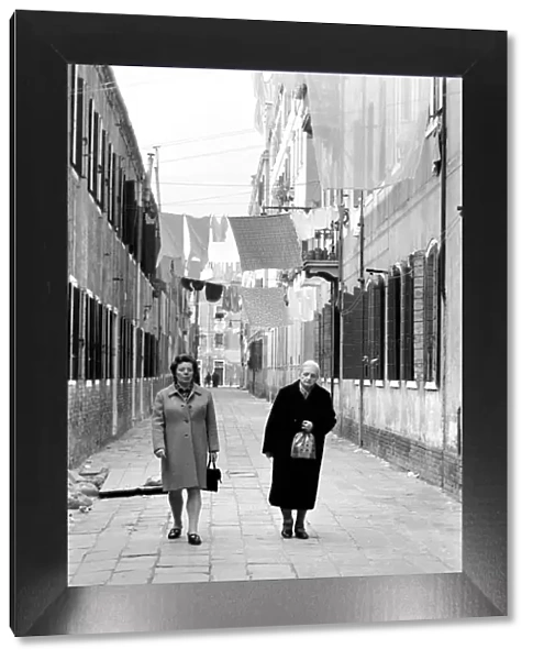 General scenes in Venice. Washing lines displaying their smalls stretch across the narrow