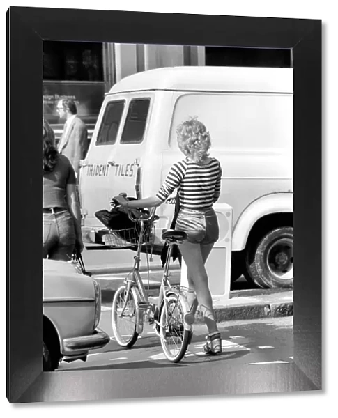 Model with a bicycle in Kings Road Chelsea, London. April 1975 75-2156-009