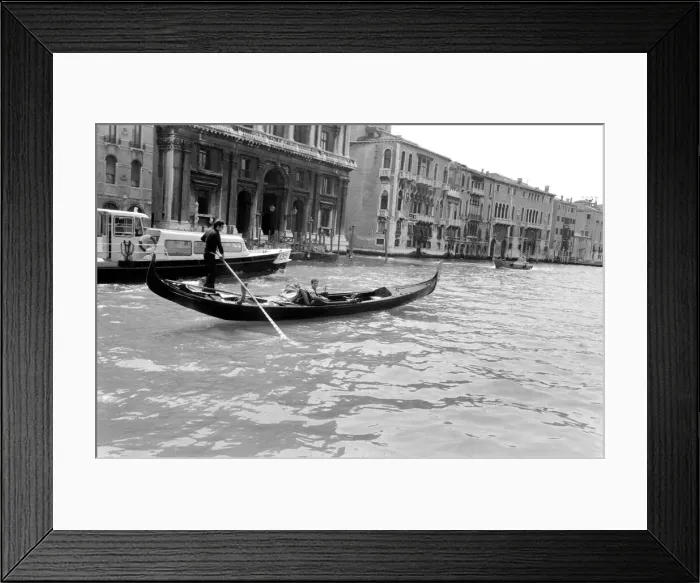 Framed Print : General scenes in Venice. A young couple take a gondola along the Grand Canal Framed Print : General scenes in Venice. A young couple take a gondola along the Grand Canal
