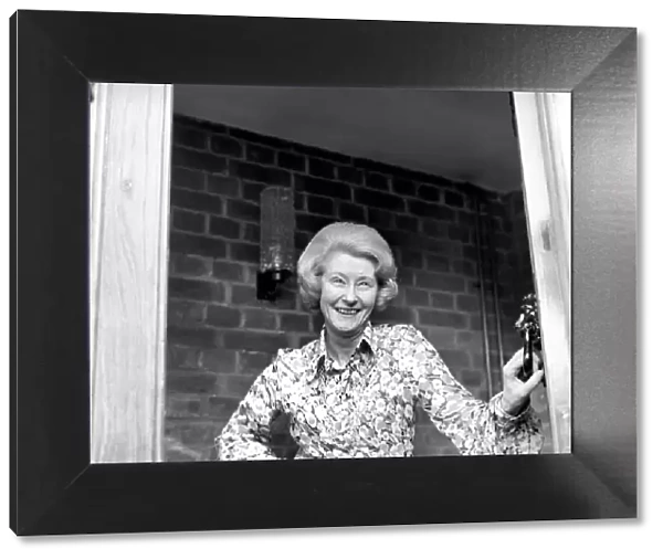 Mrs. Babette Barber looking out of her window. April 1975 75-2155