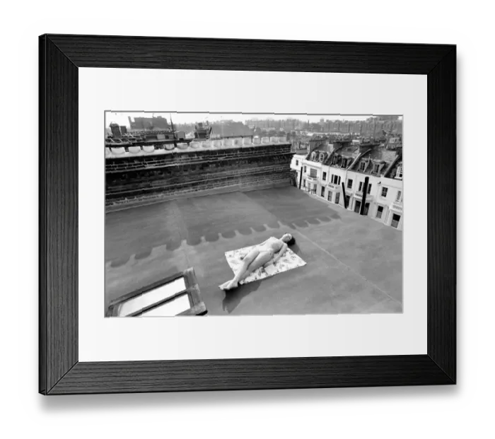 Framed Print : A model wearing a bikini as she subathes on a rooftop on Kings Road in Chelsea, London