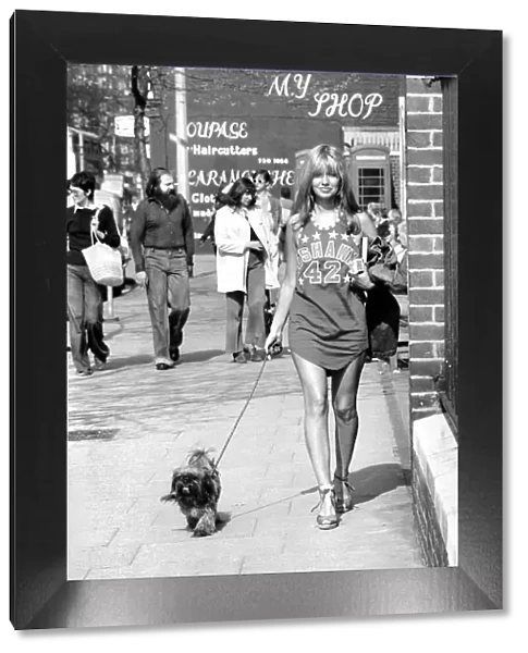 Woman taking her dog for a walk on Kings Road in Chelsea