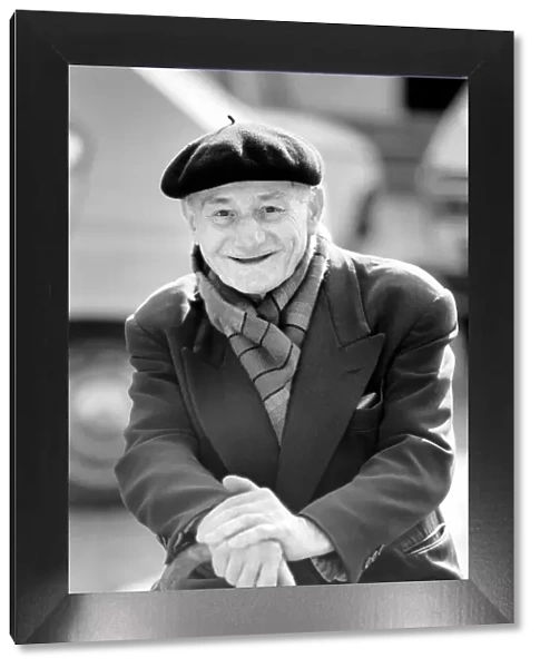 An old man of Paris wearing beret, scarf and coat on a coald day in France April