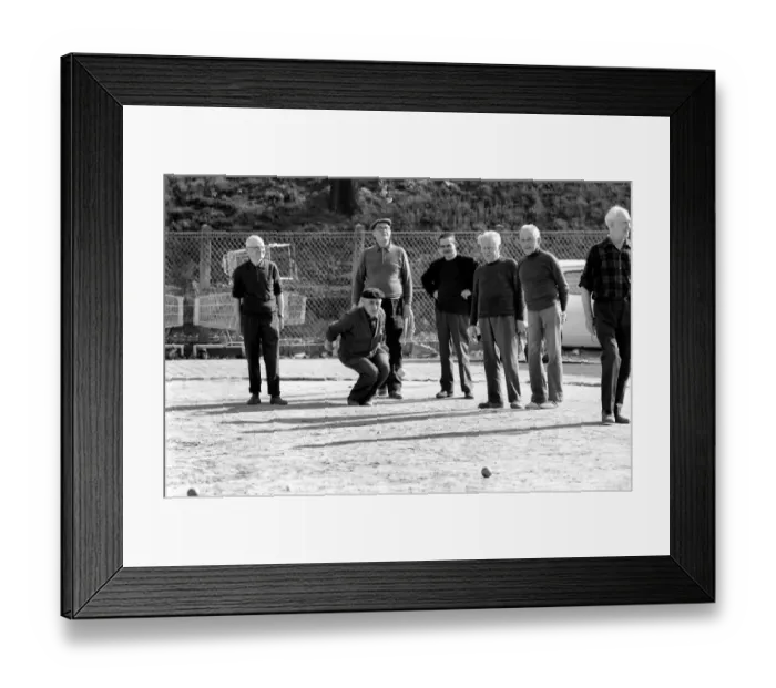 Framed Print : An old man of Paris wearing beret, scarf and coat on a cold day in France as he plays a