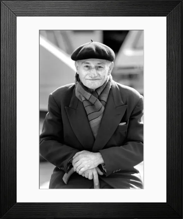 Framed Print : An old man of Paris wearing beret, scarf and coat on a coald day in France April