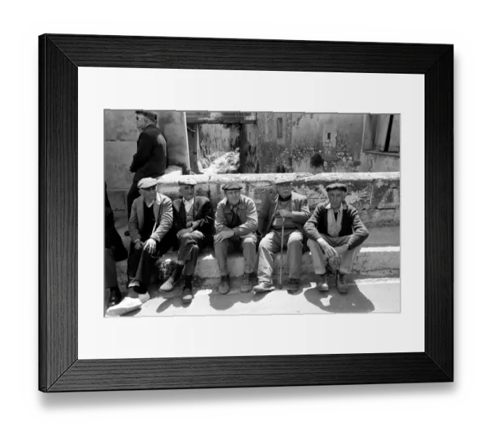 Framed Print : A group of pensioners sitting down against a wall on a street in a French village Framed Print : A group of pensioners sitting down against a wall on a street in a French village