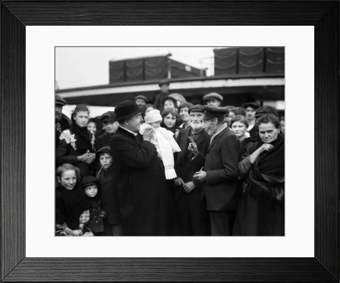 Framed Print : Father Merckx seen here with one of the youngest of the 300 Belgian refugees aboard a