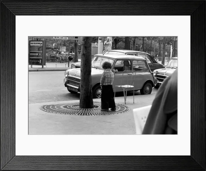 Framed Print : Young boy urinates outside a cafe on the Champs Elysees in Paris, France Framed Print : Young boy urinates outside a cafe on the Champs Elysees in Paris, France