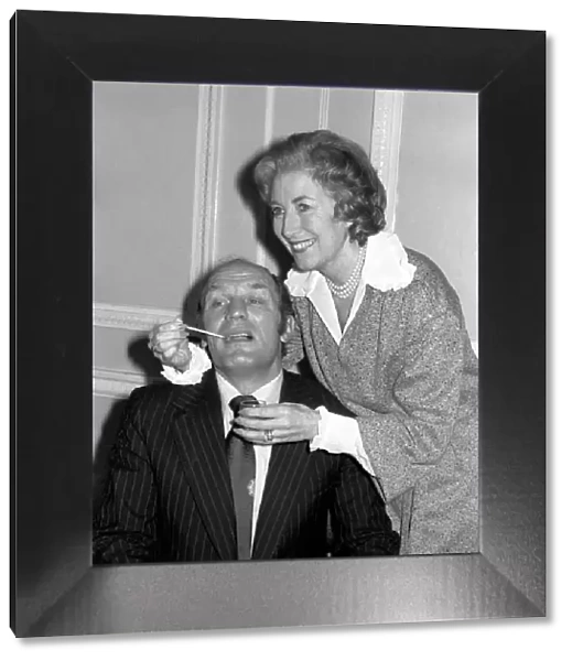Dame Vera takes the temperature of her patient Henry Cooper. January 1976 76-00059-003