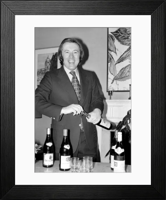 Framed Print : Wine: Mr. David Frost trying to open a bottle of wine at his home Framed Print : Wine: Mr. David Frost trying to open a bottle of wine at his home