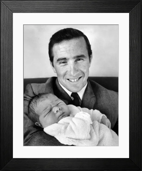 Framed Print : Proud father racing driver Jackie Stewart seen here holding his son Paul Evan Framed Print : Proud father racing driver Jackie Stewart seen here holding his son Paul Evan