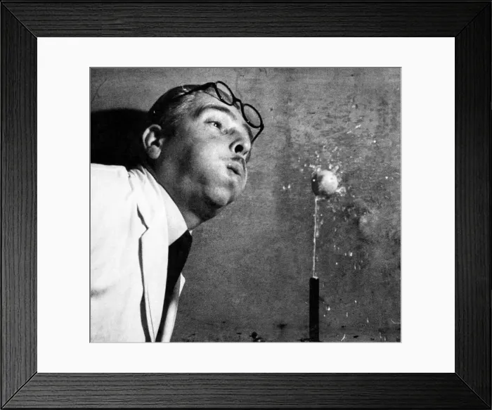 Framed Print : A scientist seen here carrying out an expiriment in high speed photography using a small Framed Print : A scientist seen here carrying out an expiriment in high speed photography using a small