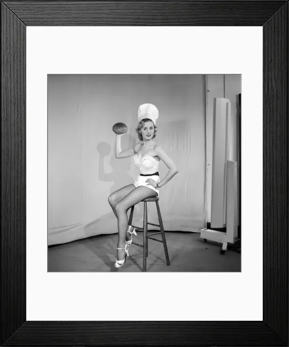 Framed Print : Woman wearing chefs hat holding loaf of bread. 1959 E61-006