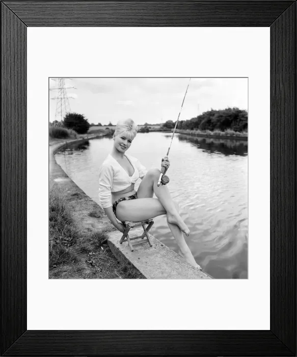 Framed Print : Clothing: Fashion: Beachwear: Model by the river bank fishing. August 1963 E490-005
